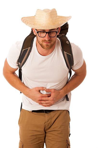 unhappy traveler showing thumbs down before hiking trip. preparing mountain backpack for hiking tour, disapproval during travel organization at home