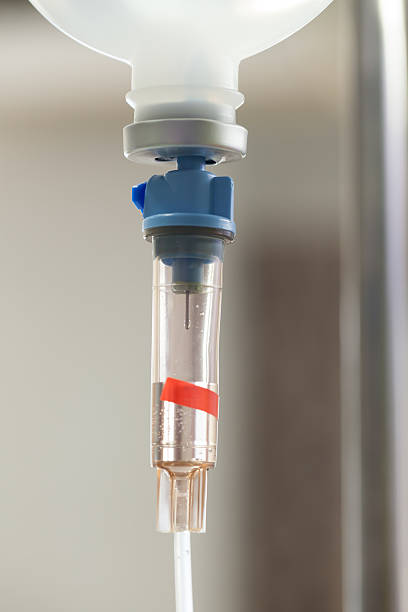 istock Close up saline IV drip for patient and Infusion pump 607297782