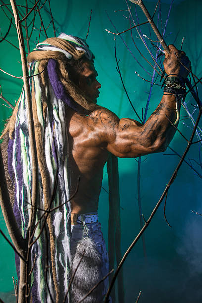 istock Muscular man with dreadlocks in the forest 607297850