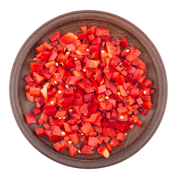 istock Sliced red pepper in a brown ceramic plate. 607297868