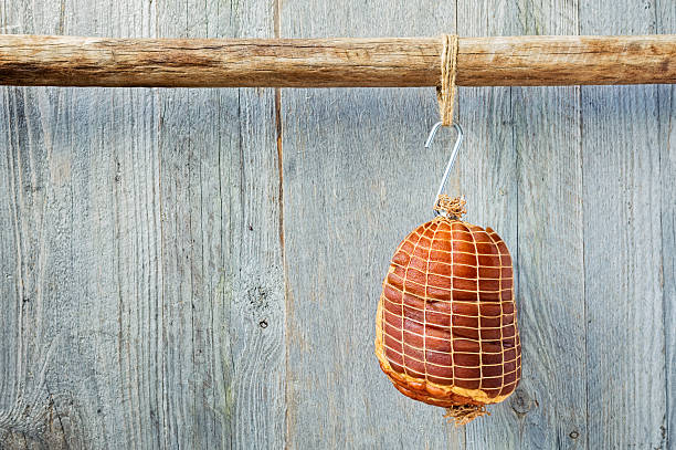 istock Hung Smoked Boneless Ham Hock Wrapped in Netting 607298362