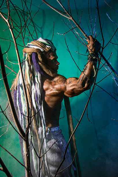 istock Muscular man with dreadlocks in the forest 607298372