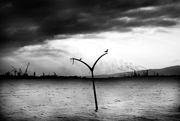 Izmit Gulf's factorys. Golcuk, Turkey - October 03, 2007 : After the 1999 earthquake of Golcuk a lamp which is  symbolise under the sea site and background Izmit Gulf's factorys destruction abstract stock pictures, royalty-free photos & images