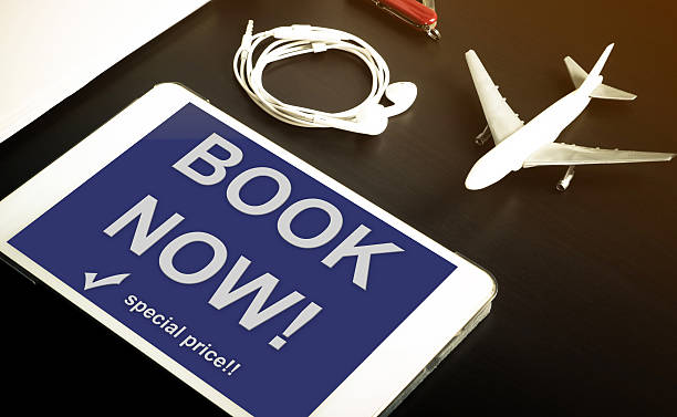 istock Book now travel agency website on Tablet screen 607300740