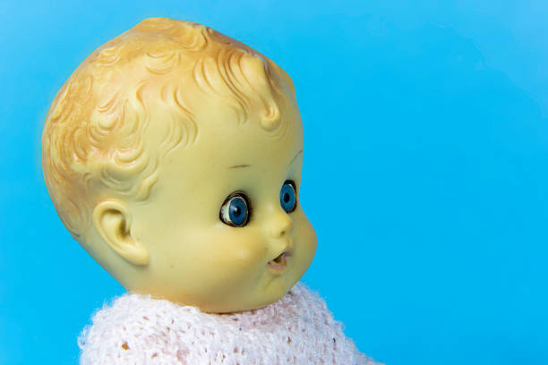 Strange female baby doll dressed in skirt and sweater open and close eyes