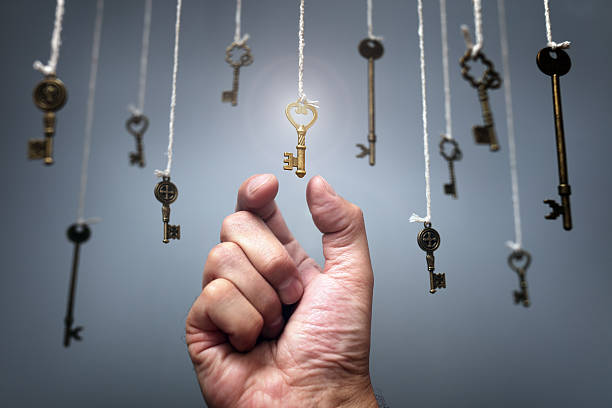 Choosing the key to success Choosing the key to success from hanging keys concept for aspirations, achievement and incentive large group of objects stock pictures, royalty-free photos & images