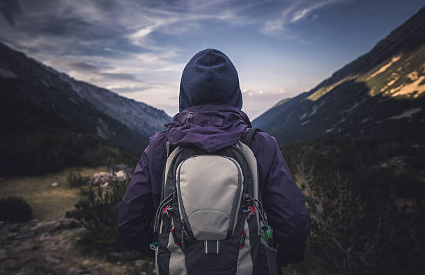 istock Traveler watching the sunset over the mountains 607302234