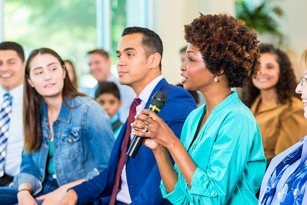 istock Concerned constituent asks politician a question during meeting 607459974