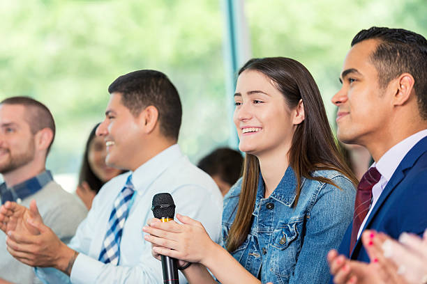 istock Diverse group of people applaud the speaker at a seminar 607460054