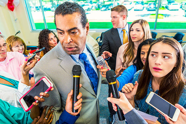 istock A crowd of journalists surround political candidate 607460266