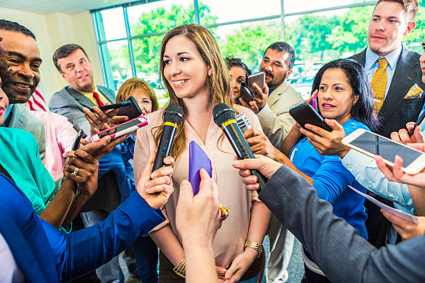 istock Cheerful female political candidate takes question from the media 607460320