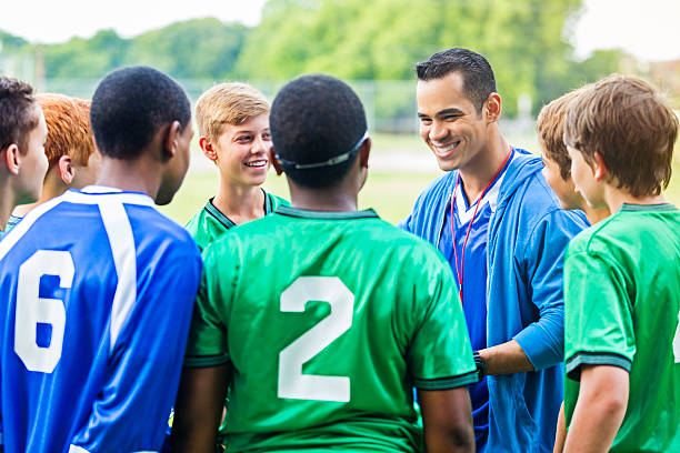 Cheerful coach encourages players before soccer game