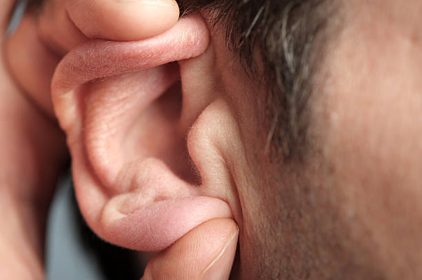 istock Close up of man cupping ear 607460928