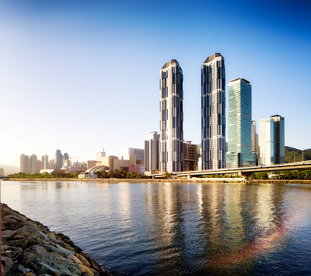 Busan Centum City skyline at sunset with river reflections. This area features tall luxury apartment buildings, hotel and of the largest malls in the wold.