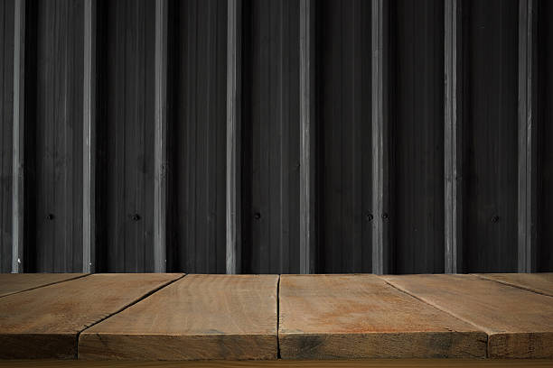 istock Wooden table with old black metal sheet. 607462608