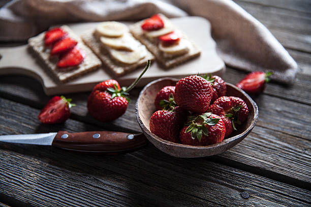 istock Fruity toast on wooden background. Strawberries 607464780