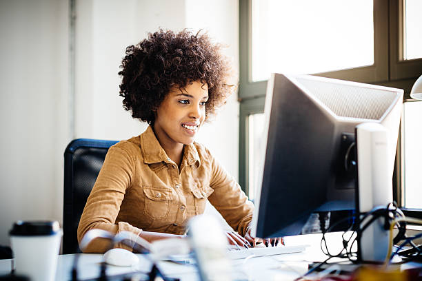 istock Young African Woman Working in Loft Space Behind Computer 607465644