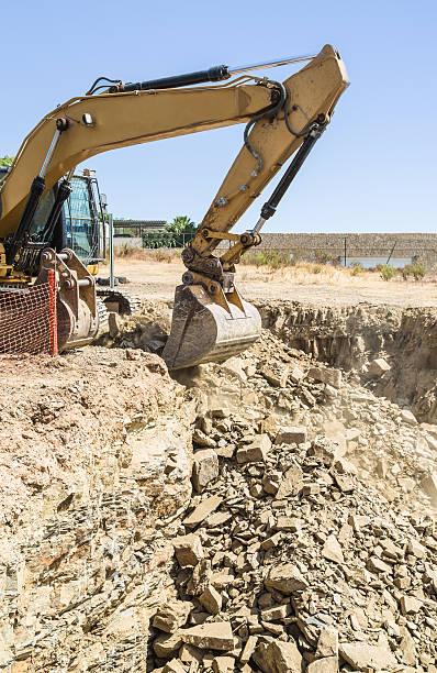 istock Excavator, digger clears ground for house building 607467260