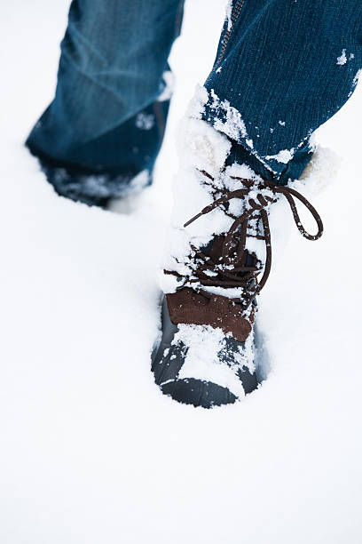 istock walking shoes in the snow 607468264