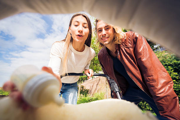 istock Young parents looking at their baby in a stroller 607469300