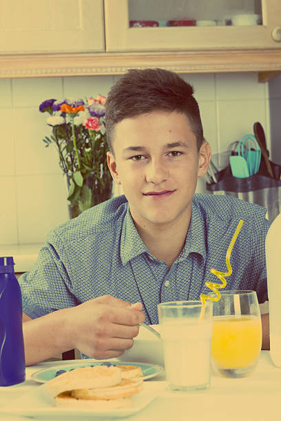 istock Boy eating healthy breakfast at home 607469502