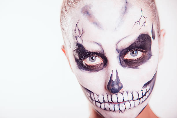 istock Girl with Halloween face art on white background 607470492