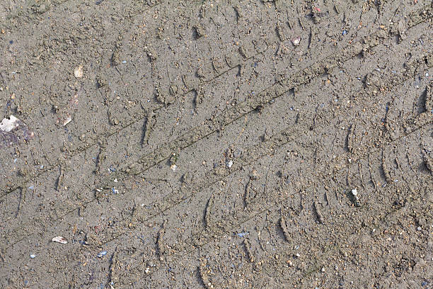 istock Wheel track on the soil. Track wheel on the ground. 607471082