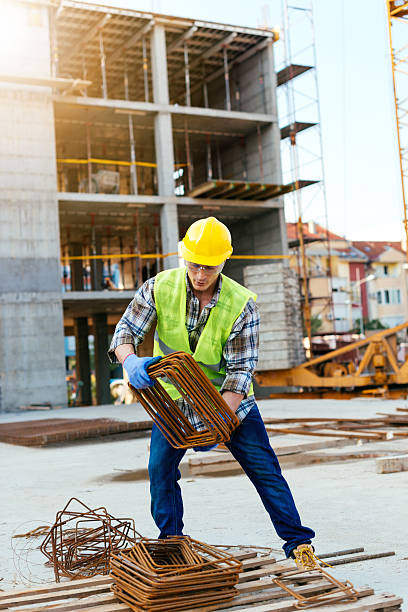 istock Strong manual worker lifting armature and steel rods 607471308
