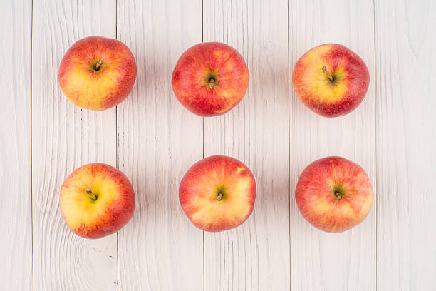 istock Red apples on the old wooden table. 607472588