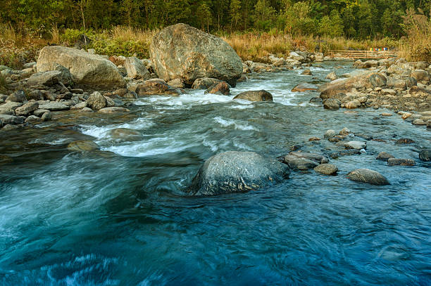 istock River water flowing through rocks at dawn 607472846