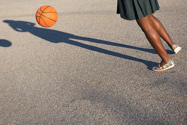 istock Student playing with basketball ball 607474796