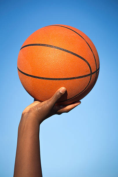 istock Holding Basketball Ball in the Air 607475324