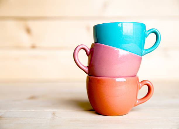istock Colored cups on the wooden background 607475640