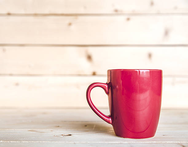 istock Red coffee cup on wooden table 607475878