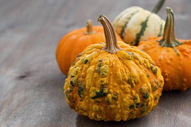 Pumpkins on a wooden background, closeup