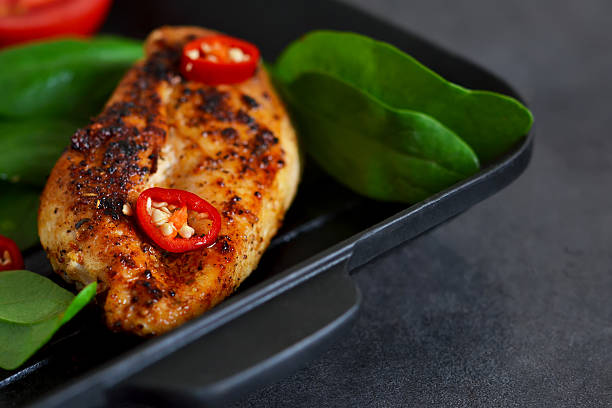 istock Chicken fillet grilled with spices and chilli. 607476094