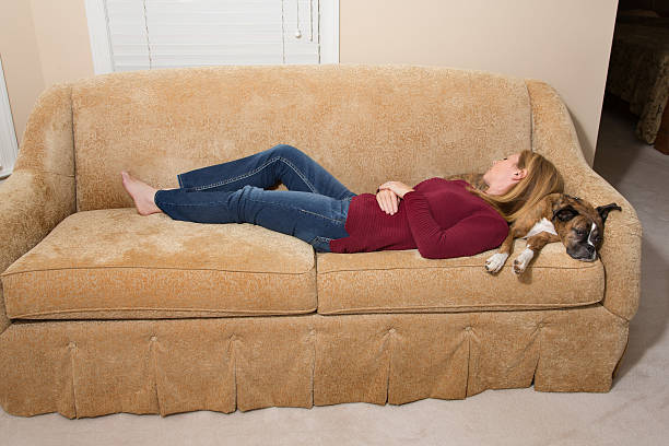 istock Woman and Dog asleep on couch 607477358
