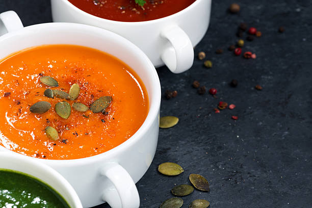 istock assortment of vegetable cream soup on and dark background 607477410