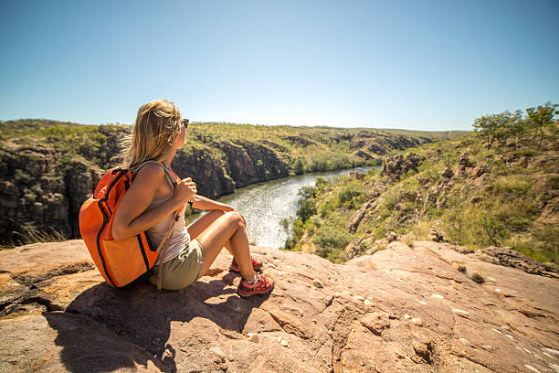 istock Hiker on mountain top looks at view 607478314