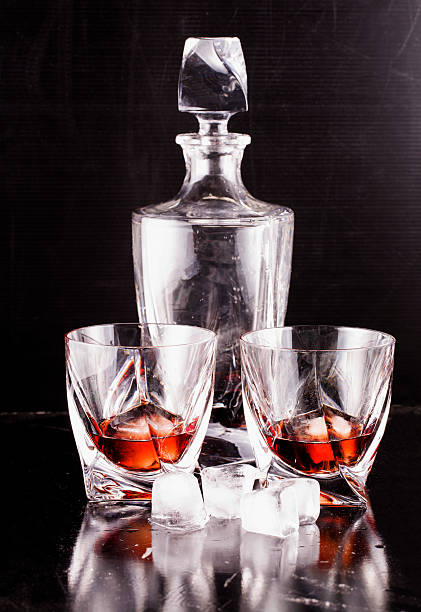 istock Liquor bottle and glasses 607478526