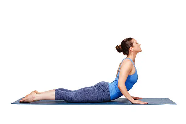 Photo of Sporty fit yogini woman practices yoga asana bhujangasana