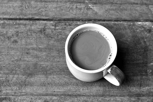 istock Hot coffee on wooden plank in lowkey black and white 607483672