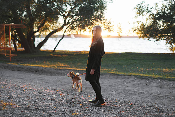 istock Woman walking with red dog 607483954