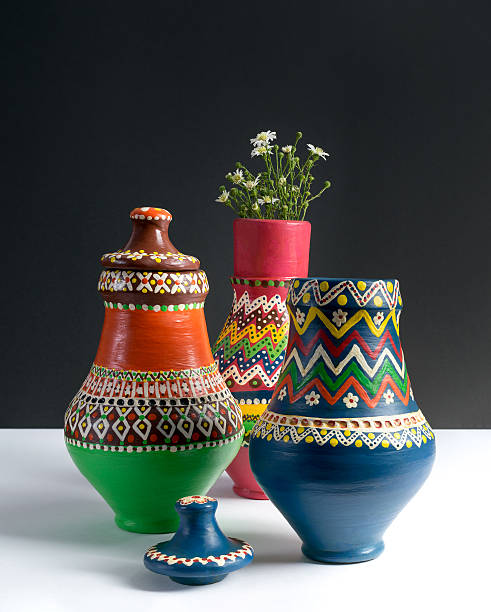 istock Three decorated pottery vases with small flowers 607484266