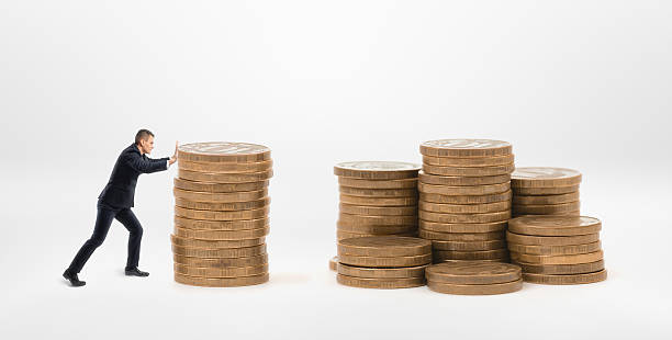 istock Small businessman pushing a stack of golden coins to another 607484466