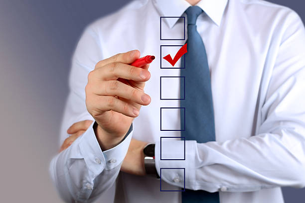 istock Businessman making vote by a red pen 607484698