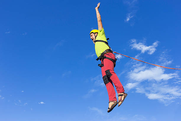istock Jump rope from a high rock in the mountains. 607484920