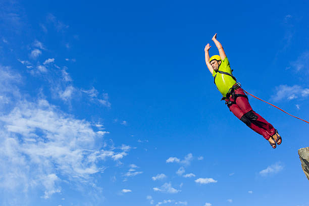 istock Jump rope from a high rock in the mountains. 607485038