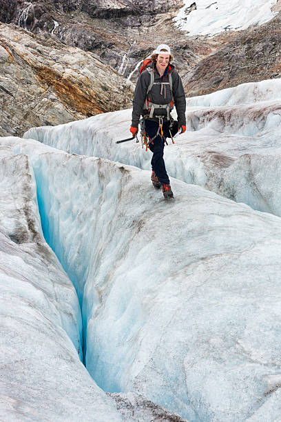 istock Man hiking on glacier between crevasses 607485098