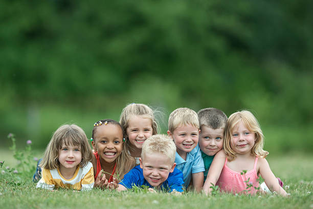 istock Children Laughing in the Grass 607486118